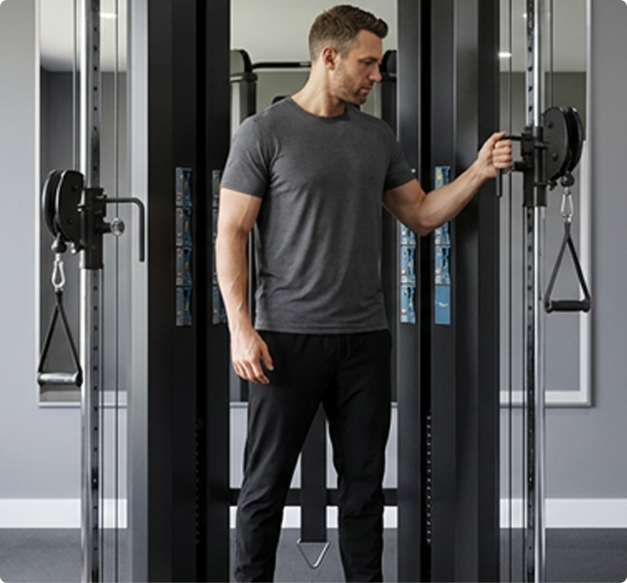 Man using a Vision Fitness 300-FT Functional Trainer in a home gym setting