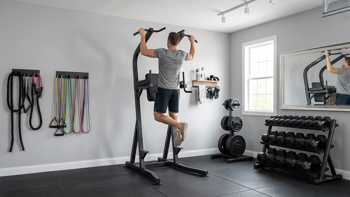 Man exercising with a Vision Fitness 300-VKR Vertical Knee Raise Station in a home gym.